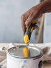 OLFA 18mm LA-X / L-5 Fiberglass Utility Knife with Multi-Pick shown opening a paint can with drop cloth in background